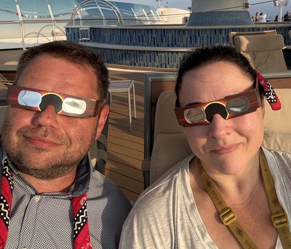 Waiting on deck in eclipse glasses